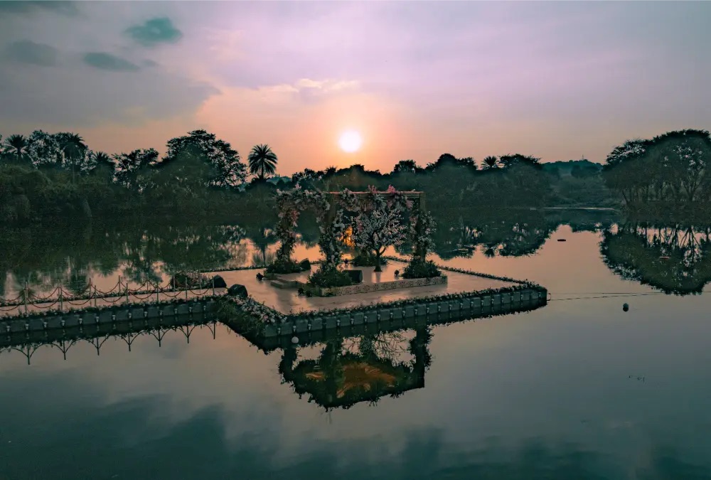 Sunset over the floating mandap at Aura by Area83
